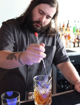 Eclipse bar manager Tony Saputo stirs Gut Check up a cocktail. - Evan C. Jones