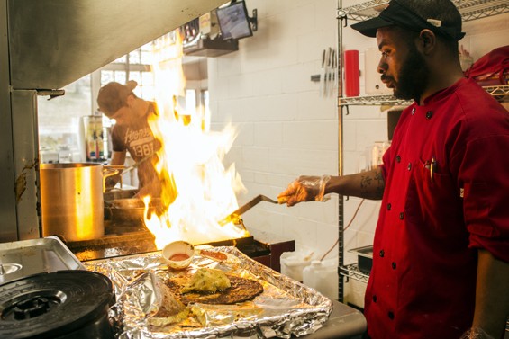 Fort Taco cook Montel Bosley flame grills tortillas for enchiladas. | Mabel Suen