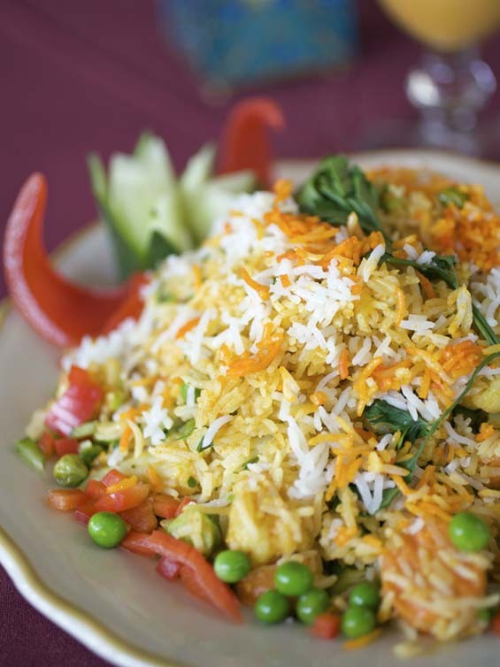 Vegetable biryani is saffron-flavored basmati rice prepared with cashews, almonds and raisins and, in this case, served with vegetables. See full slideshow here. - Photo: Jennifer Silverberg