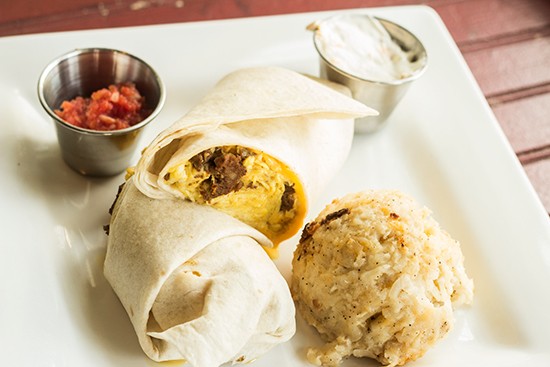 "South of the Border" breakfast burrito with egg, American cheese, chorizo sausage and jalapenos with fiesta sour cream and salsa. Served with potatoes.