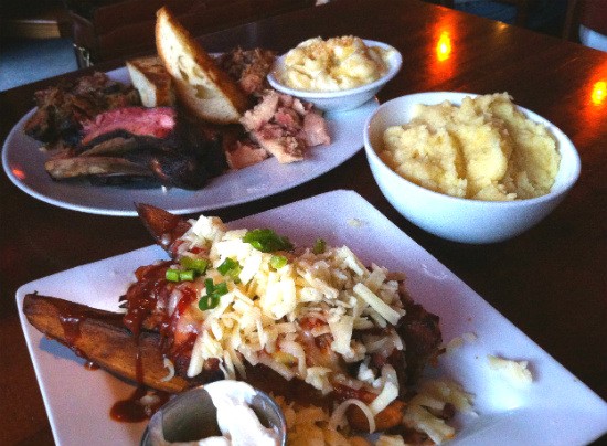 Loaded smoked potato wedges, the "Big Jimmy" sampler and caramelized onion mashed potatoes at the Shaved Duck. - Liz Miller