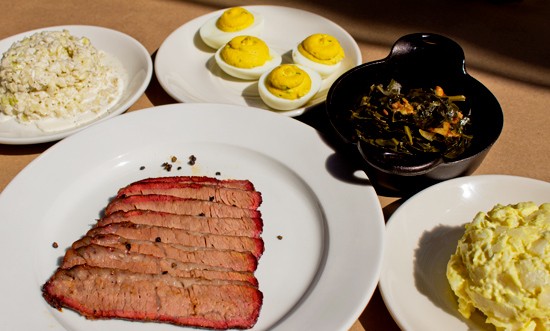 Smoked brisket with sides of cole slaw, deviled eggs, bacon braised greens and potato salad. - Mabel Suen