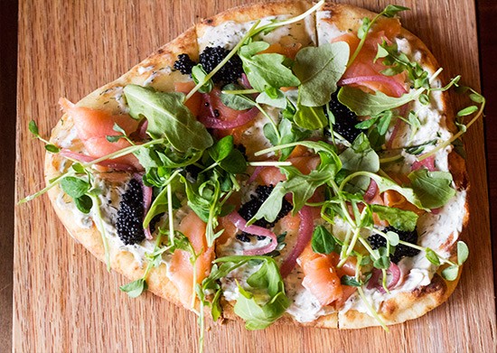 "Russian Flat Bread" with salmon, dill creme fraiche, caviar, pickled onions and greens.