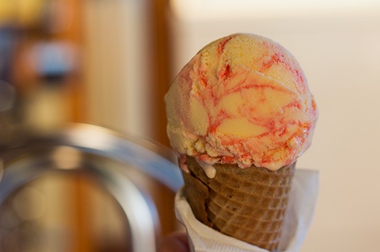 Strawberry cheescake ice cream in a sugar cone.
