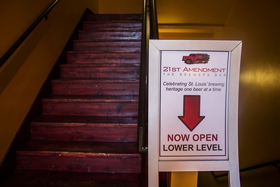Signage pointing down the stairs.