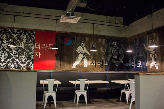 Murals of luchadors in marital arts gear illustrate the fusion concept.
