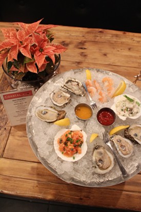 Coastal Bistro and Bar's seafood tasting tower, served on an elevated platter. - Mabel Suen