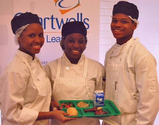 The winning team of student chefs in St. Louis' Healthy Schools Campaign Cooking up Change contest pose with their first-place meal. - image via