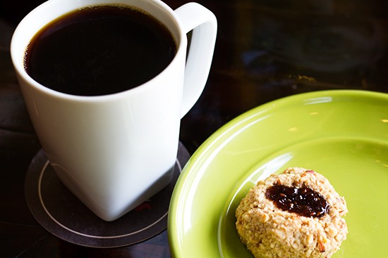 "Malawi Peaberry" pour-over coffee with a Whisk thumbprint cookie at Kitchen House Coffee. | Mabel Suen