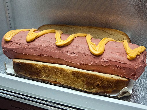 Not something you expect to find in a freezer, this hot-dog cake is made with yellow cake, strawberry icing and topped with a lemon curd to resemble mustard. - PHOTO: STEW SMITH
