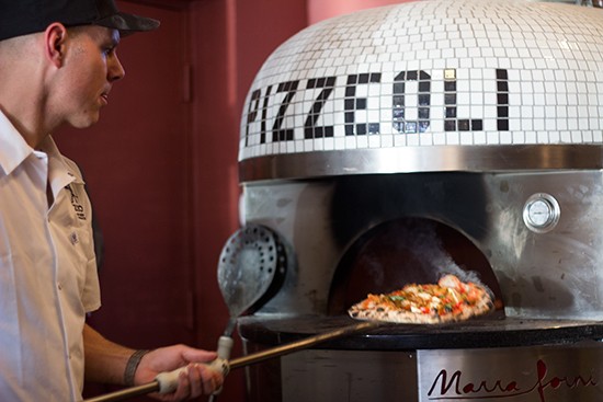 Scott Sandler with Pizzeoli's custom oven. | Mabel Suen