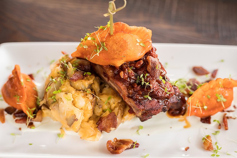 The "For The Party" dinner entree includes St. Louis-style ribs, a buffalo chicken potsticker, bacon-cheddar mashed potatoes and bleu cheese sauce. - MABEL SUEN