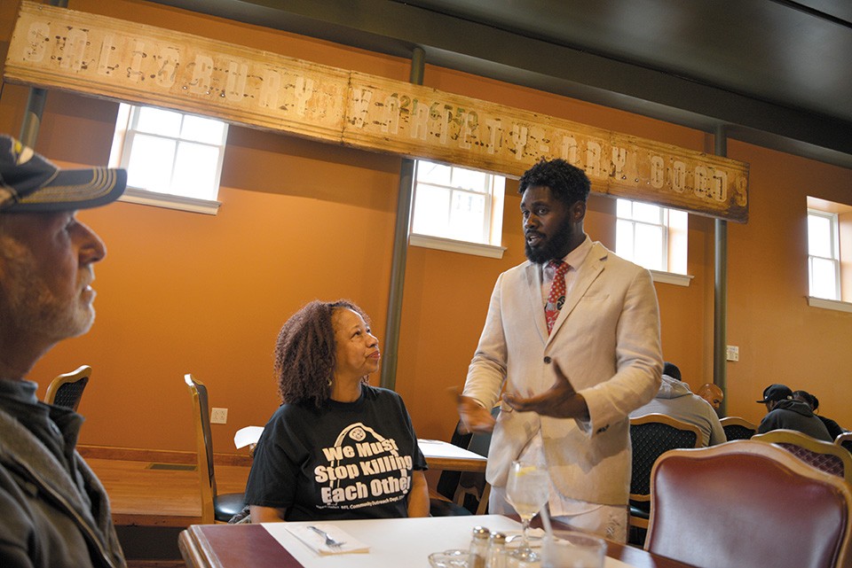Alderman Brandon Bosley works the room at the River Lillie, one of two newly opened eateries in Hyde Park. City Commissioner of Recreation Evelyn Rice, center, hears him out. - TOM HELLAUER