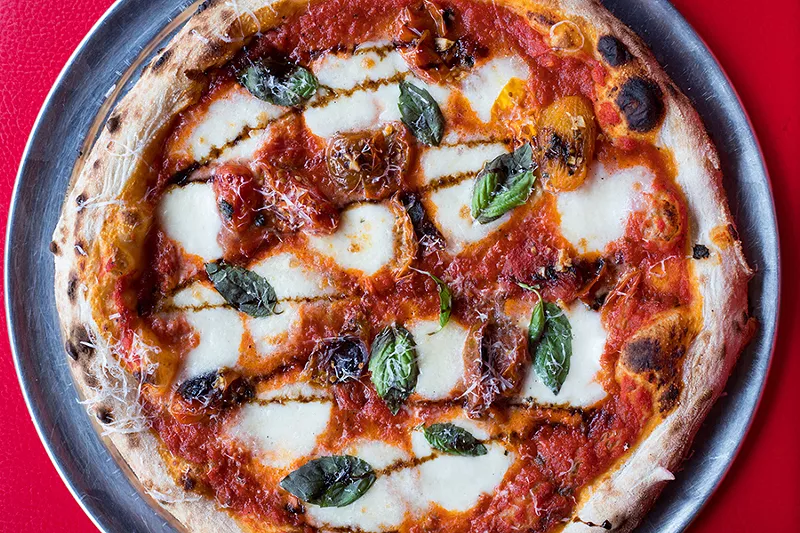 Cork n’ Slice’s margherita is topped with wood-fired San Marzano tomatoes, fresh mozzarella, balsamic glaze and basil. - MABEL SUEN