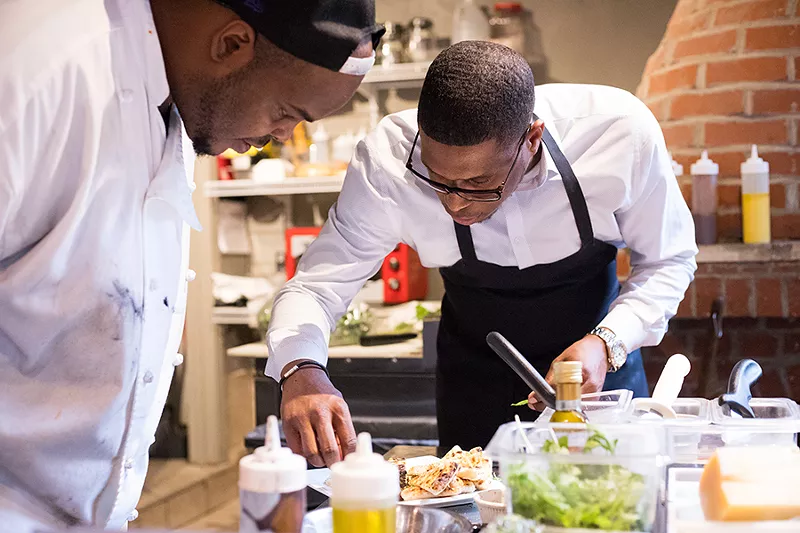 Thirdkill (right) and cook Deveon Nowden see to some finishing touches. - MABEL SUEN