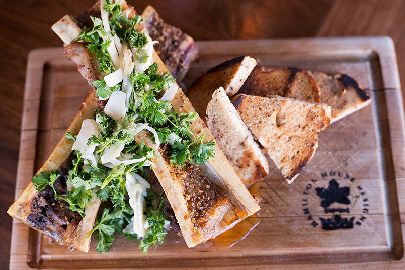 Roasted bone marrow is served with a parsley-fennel salad. - MABEL SUEN