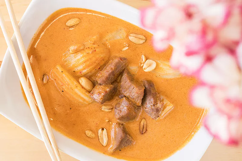 Massaman beef is slow-cooked in curry sauce with coconut milk, peanuts, potatoes and white onions. - MABEL SUEN