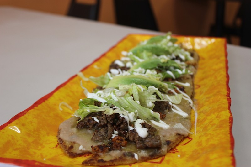 Sol Azteca's signature huarache, served with chicken, steak and chorizo, is definitely more than a mouthful. - SARAH FENSKE