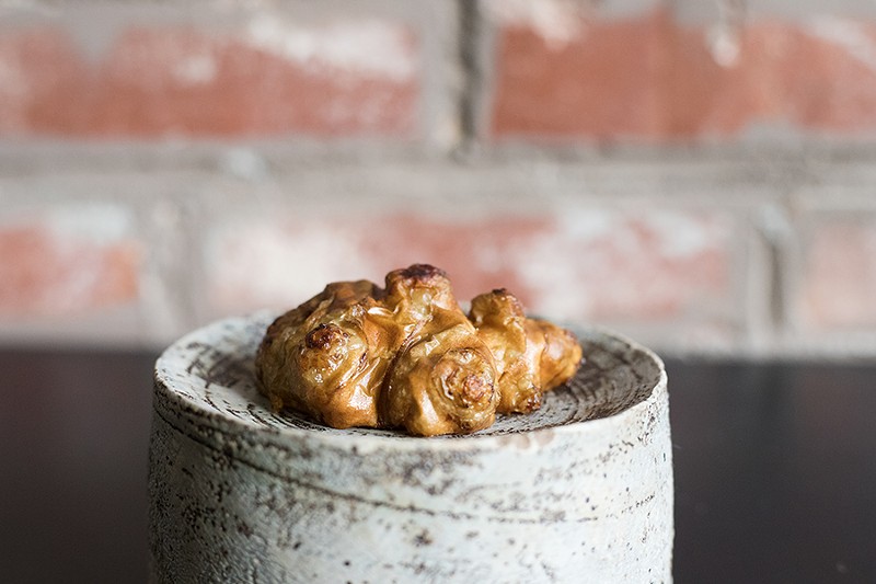 Savage’s roasted sunchoke is filled with a puree made from blackened salsify and roasted chicken skin. - MABEL SUEN
