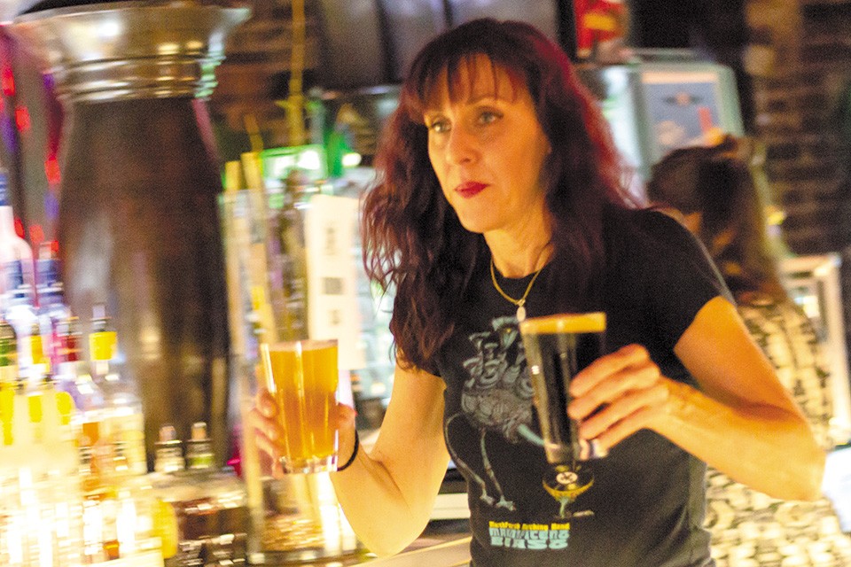 Cindy Capps keeps the beer flowing at Old Rock House. - RYAN GINES
