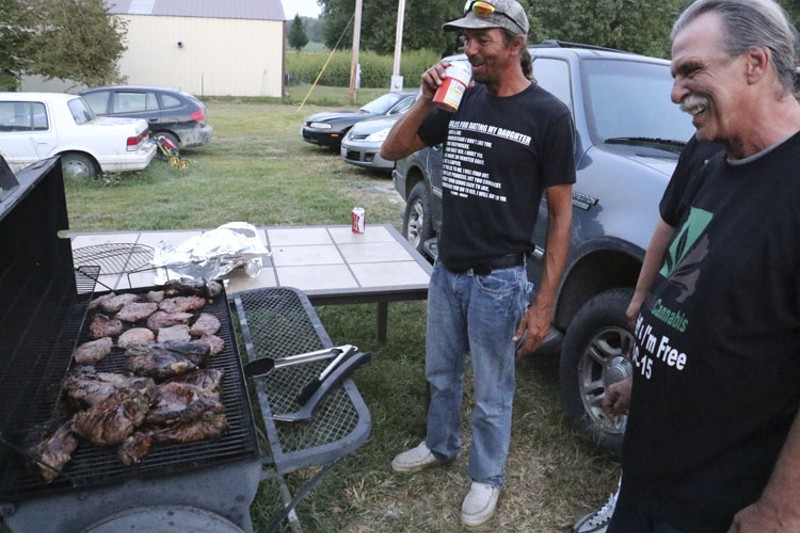 Mizanskey after his release, barbecuing with son Robbie. - RAY DOWNS
