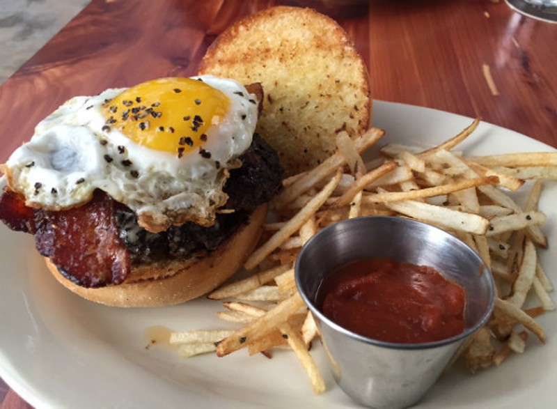 The Farmhouse Burger — two smashed patties, topped with bacon and a peppery eggs. - PHOTO BY SARAH FENSKE