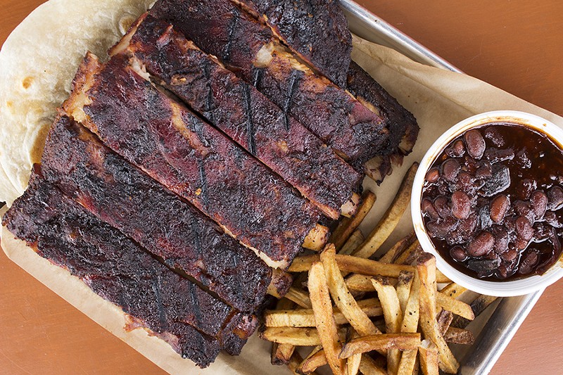 A full rack of spare ribs with hand-cut fries and pit beans. - Mabel Suen