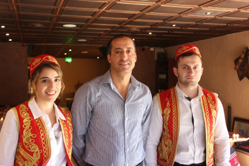 Owner Safa Marmarchi, center, with two servers at Sheesh Restaurant. - Photo by Sarah Fenske