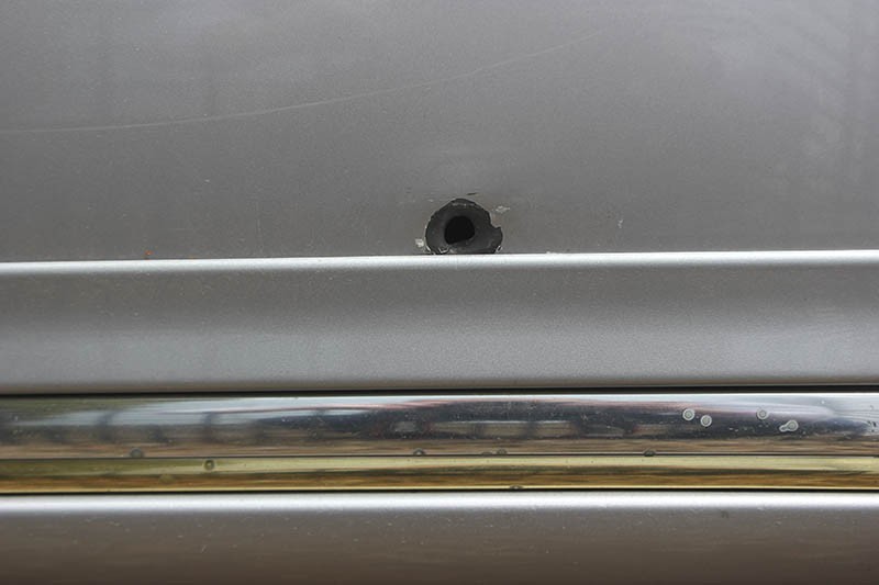 A bullet hole in the side of his Cadillac is a reminder of the first time someone tried to kill James Cobb Jr.