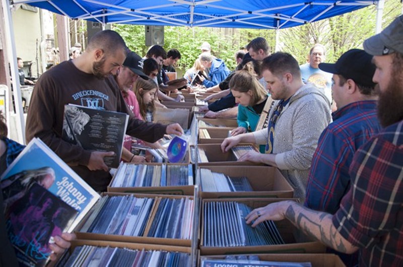Eager shoppers paw through records at Euclid's outdoor tent at last year's Record Store Day party. - Photo by Micah Usher