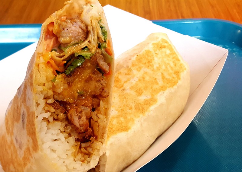 Kalbi's Spicy Pork Burrito is one of the four variations of burritos offered at the shop. Each meal comes with an option of four different proteins: boneless beef short rib, sweet and spicy chicken, spicy pork and tofu. - Kavahn Mansouri