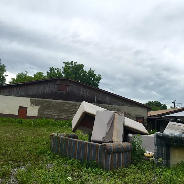 The couches that previously graced the "couples theater" now form a sad pile behind the building. - PHOTO BY THOMAS CRONE