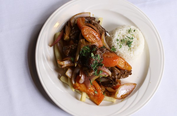 Lomo Saltado: Sauteed tenderloin steak, served with onions, tomatoes, rice and fries. - CHELSEA NEULING