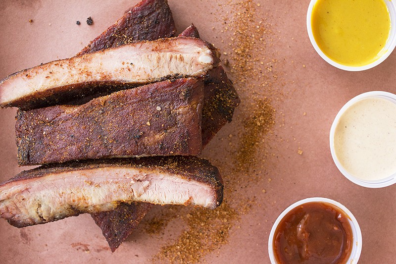 Ribs with a selection of sauces. - PHOTO BY MABEL SUEN