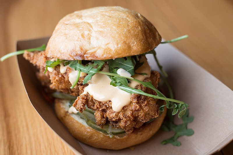 Brasswell’s chicken sandwich is topped with arugula and Crystal aioli. - MABEL SUEN
