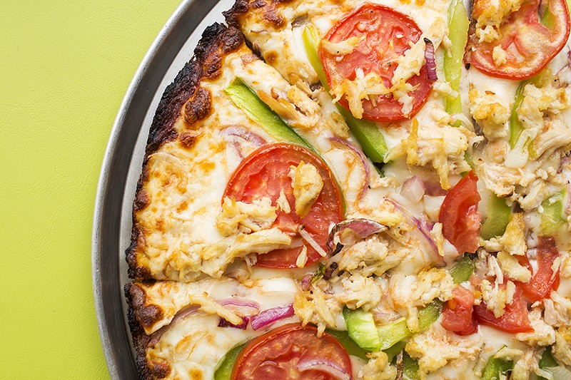 The garlic chicken pizza features tomato, red onion and green pepper — on gluten-free crust. - PHOTO BY MABEL SUEN