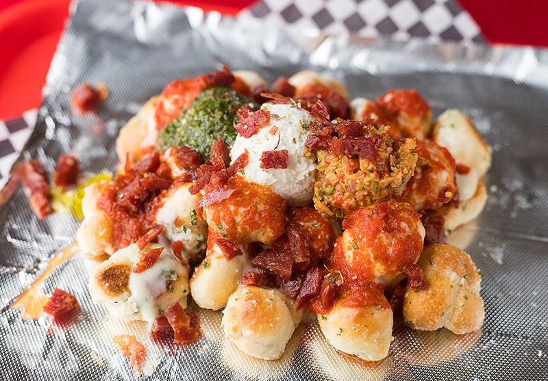 What could be better than garlic knots smothered in cheese sauce and marinara and topped with pepperoni chunks, ricotta cheese, housemade tapenade and basil pesto? - MABEL SUEN