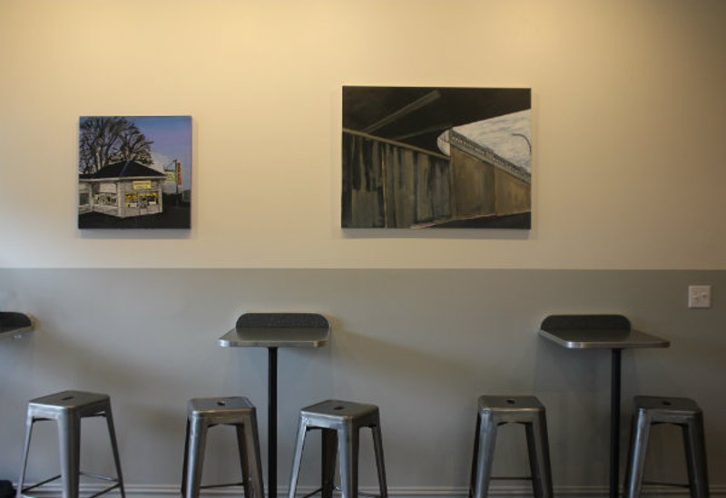 Artwork featuring iconic local spots decorates the walls. - CHERYL BAEHR