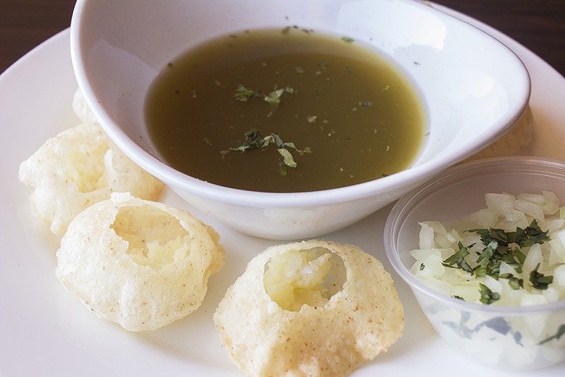 Pani puri filled with spiced potatoes and onions. - PHOTO BY MABEL SUEN