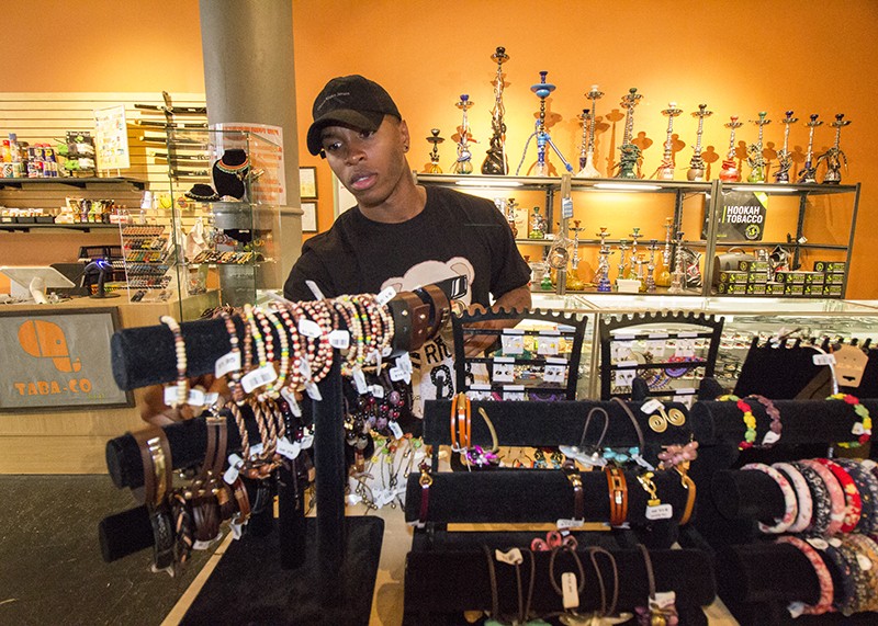 Williams browses some items at Tabo-Co, a smoke shop and novelty gift store. - PHOTO BY MABEL SUEN