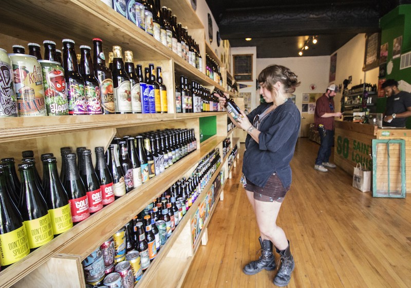 Nicole Casper browses the selection at Saint Louis Hop Shop. - PHOTO BY MABEL SUEN