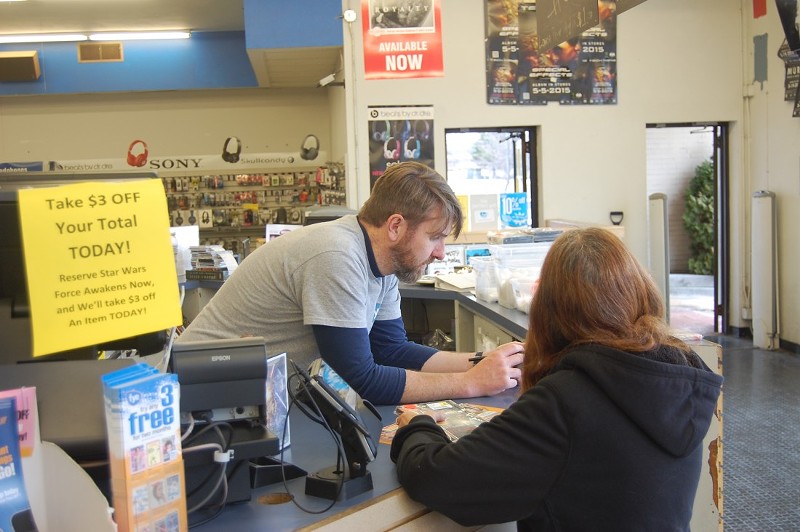 Scott Burk assisting a customer. - Photo by Harlan McCarthy