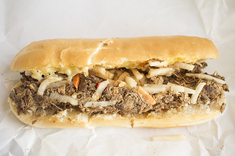 The jerk chicken sandwich consists of jerk-braised chicken thighs, habanero-jack cheese and Jamaican slaw. - PHOTO BY MABEL SUEN