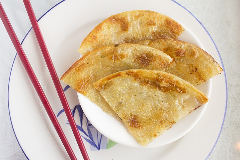 Scallion pancake: Flour dough, studded with scallions and pan-fried, then cut into triangles. - PHOTO BY MABEL SUEN