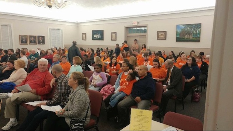 Orange-shirted pro-pit activists filled multiple rows at Florissant City Hall. - PHOTO COURTESY OF MANDY RYAN