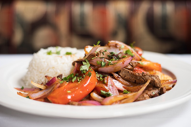The lomo saltado features sauteed marinated tenderloin steak, red onions and tomatoes, served with french fries and rice. - MABEL SUEN