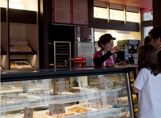 A worker greets customers at Piccione Pastry in 2013. - MABEL SUEN
