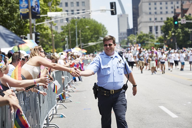 A police officer marches in the 2019 Pride St. Louis parade. - THEO WELLING