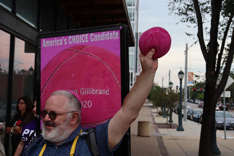 Marc Daniels holds up pink yarmulkes emblazoned with "Kirsten Gillibrand 2020." - JAMES POLLARD
