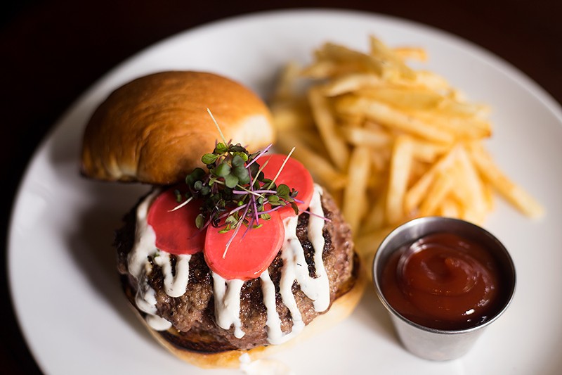 A sophisticated burger made of ground flap steak is served on a challah bun with pickled radish and horseradish aioli. - MABEL SUEN